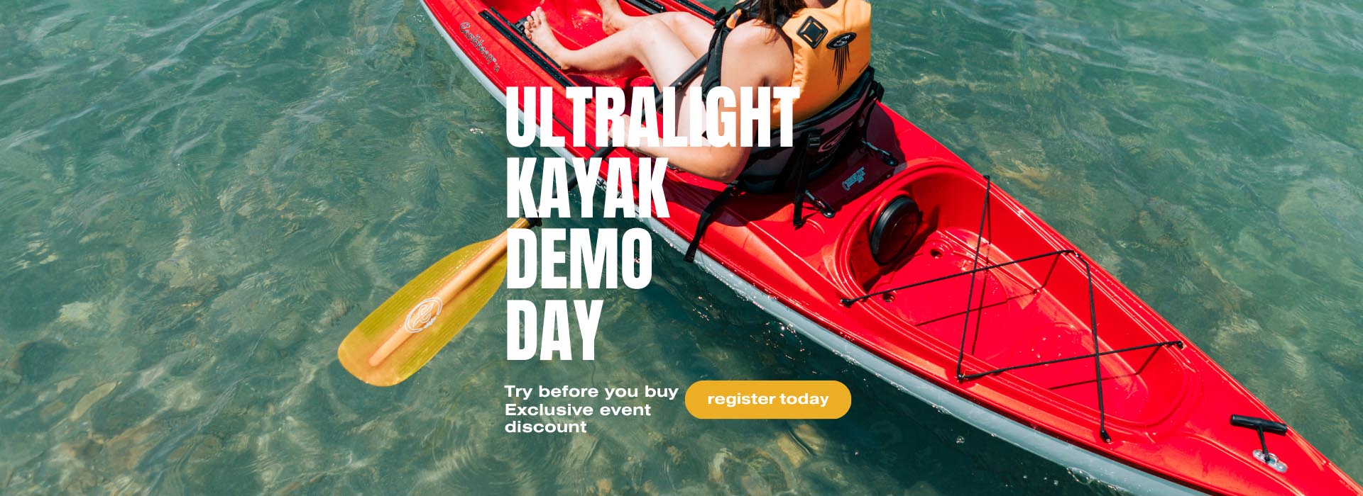 Eddyline Ultralight Kayaks demo day April 25th 2-6pm at Kenco Outfitters. A bright red kayak seen from above, paddling on clear, turquoise water.